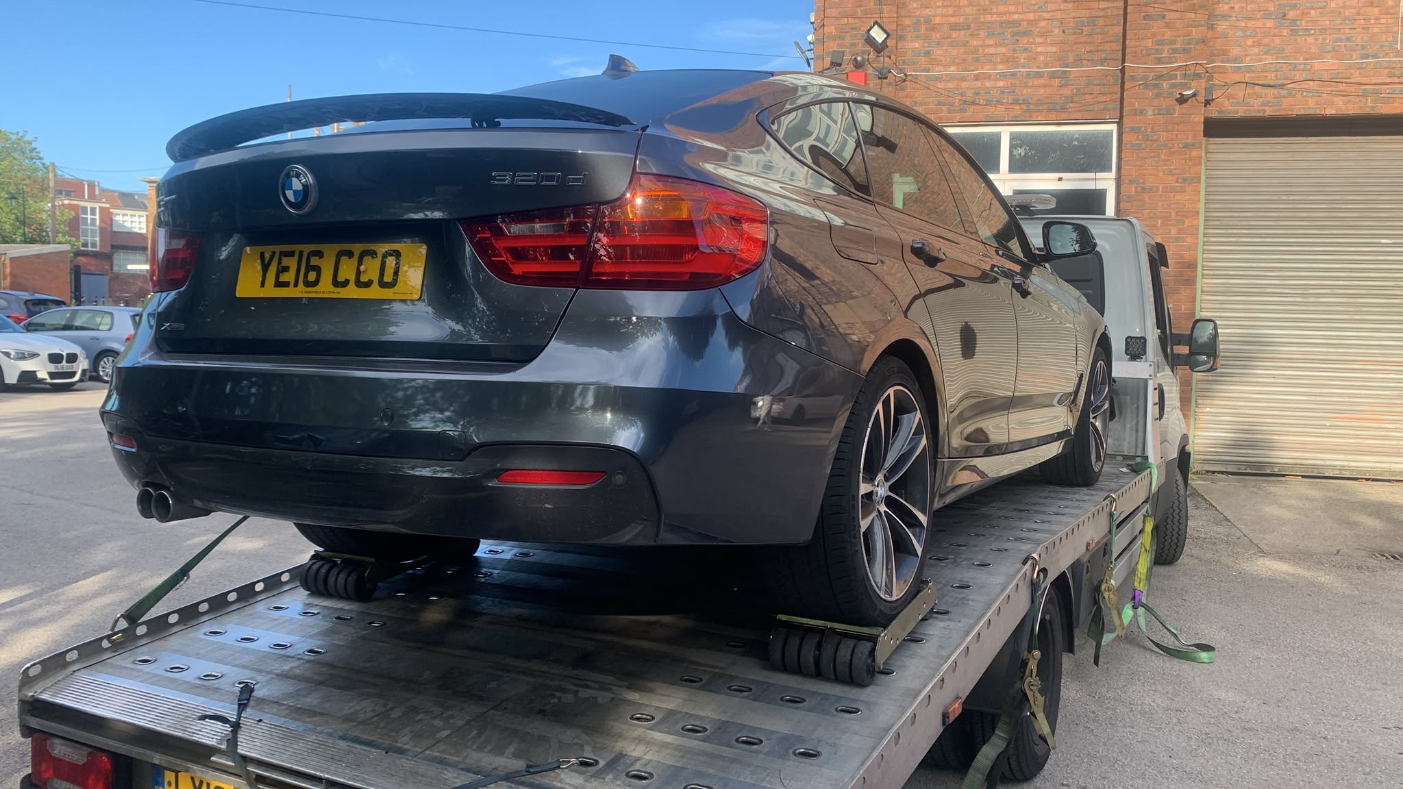 BMW car secured on a flatbed vehicle transporter